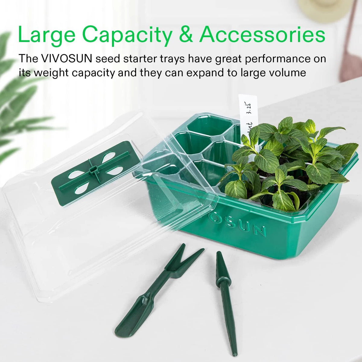 A VIVOSUN seed starter tray set shown on a light surface with a clear lid, a green multi-compartment tray holding small green plants, and two dark green hand tools. Text at the top highlights large capacity and accessories.