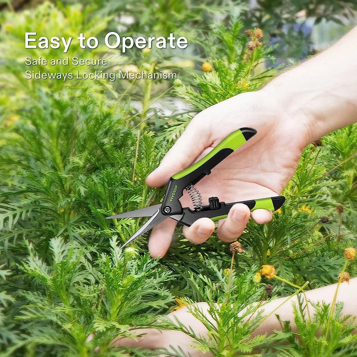 A hand holding a green and black pruning shears among green garden foliage, with text overlay that reads 'Easy to Operate Safe and Secure Sideways Locking Mechanism'.