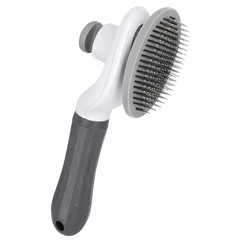 Pet grooming brush with white handle and gray bristle side on a white background