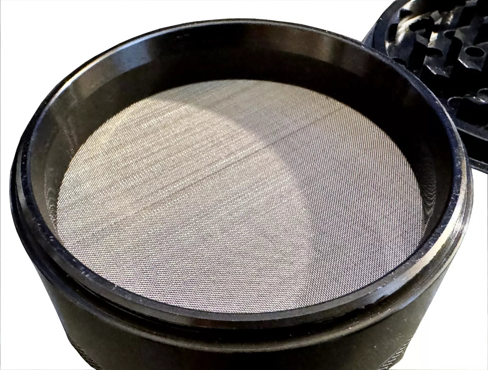 Fine mesh screen in 4 piece Crush Labs Aluminum herb grinder.