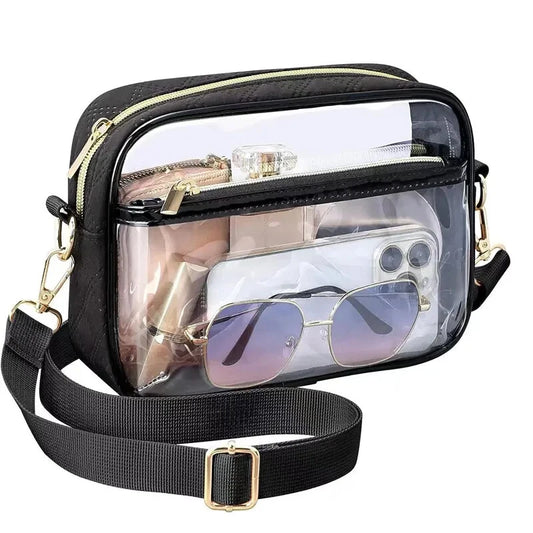 A clear crossbody purse hand bag with black trim and an adjustable strap, showing a transparent PVC body with zipped compartments and an extendable strap.