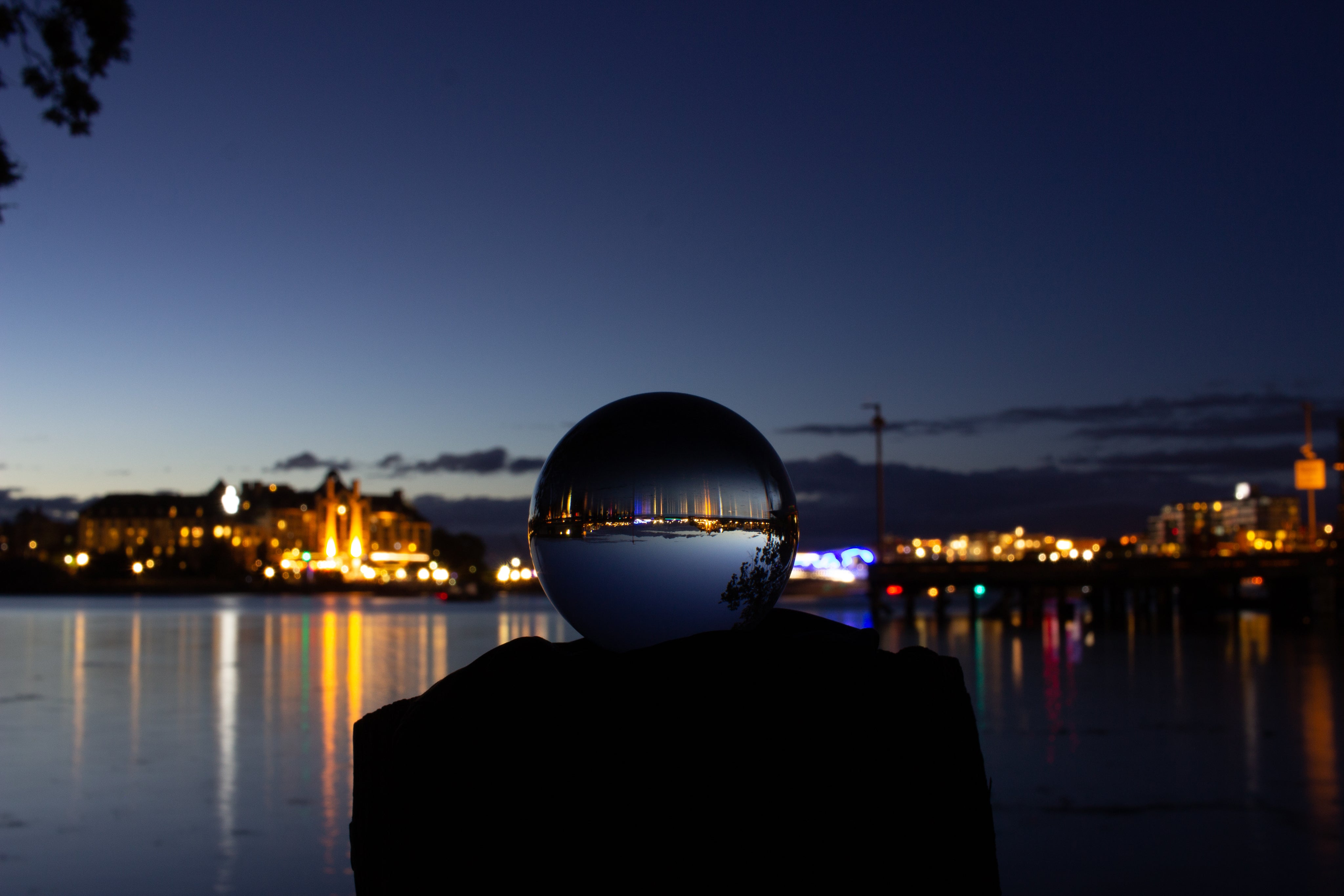 glass ball, with water and bright lights in background