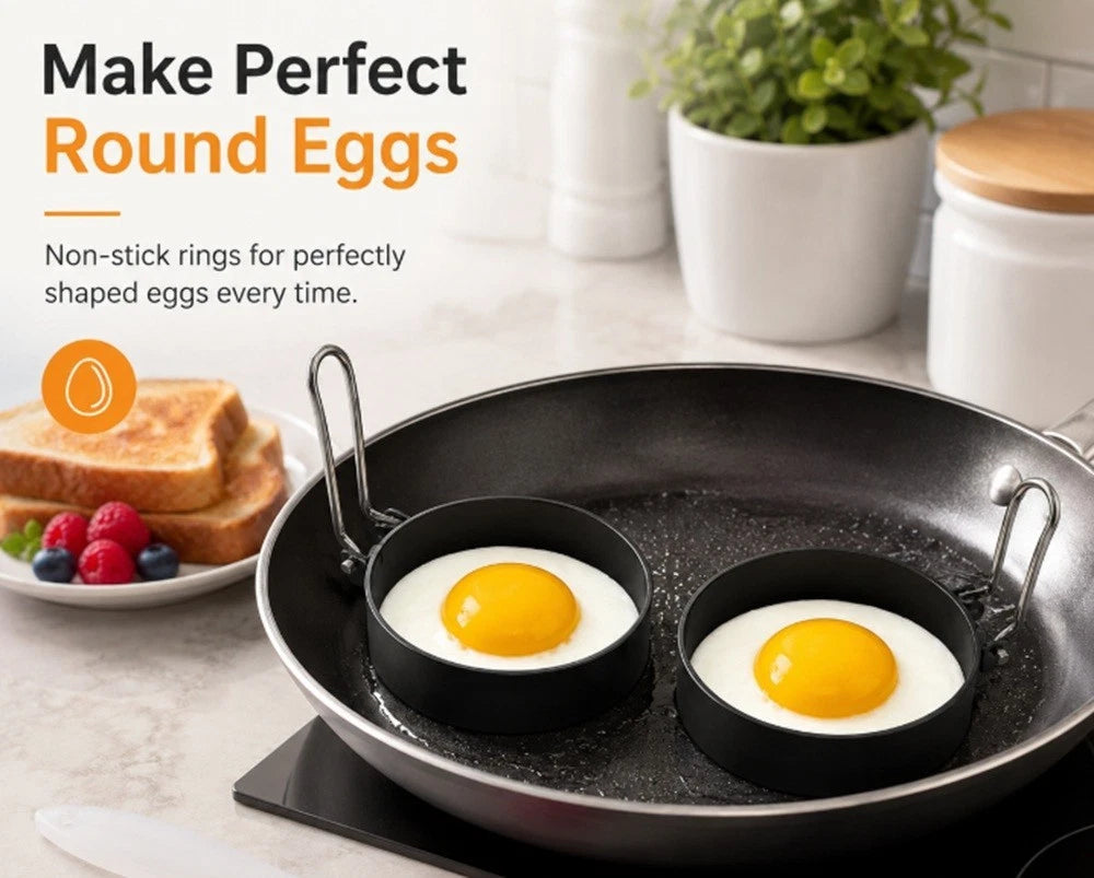 Non-stick egg shaping rings in a frying pan with eggs on a kitchen counter.