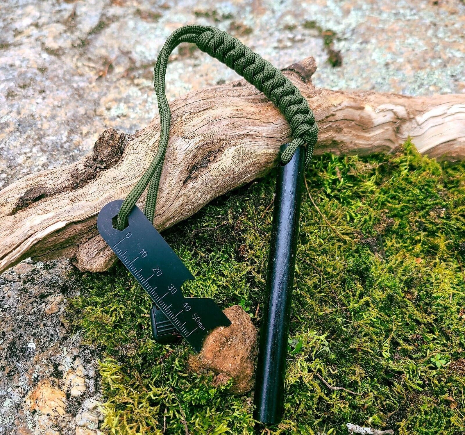Fire starter with green rope and scraper tool on a natural background