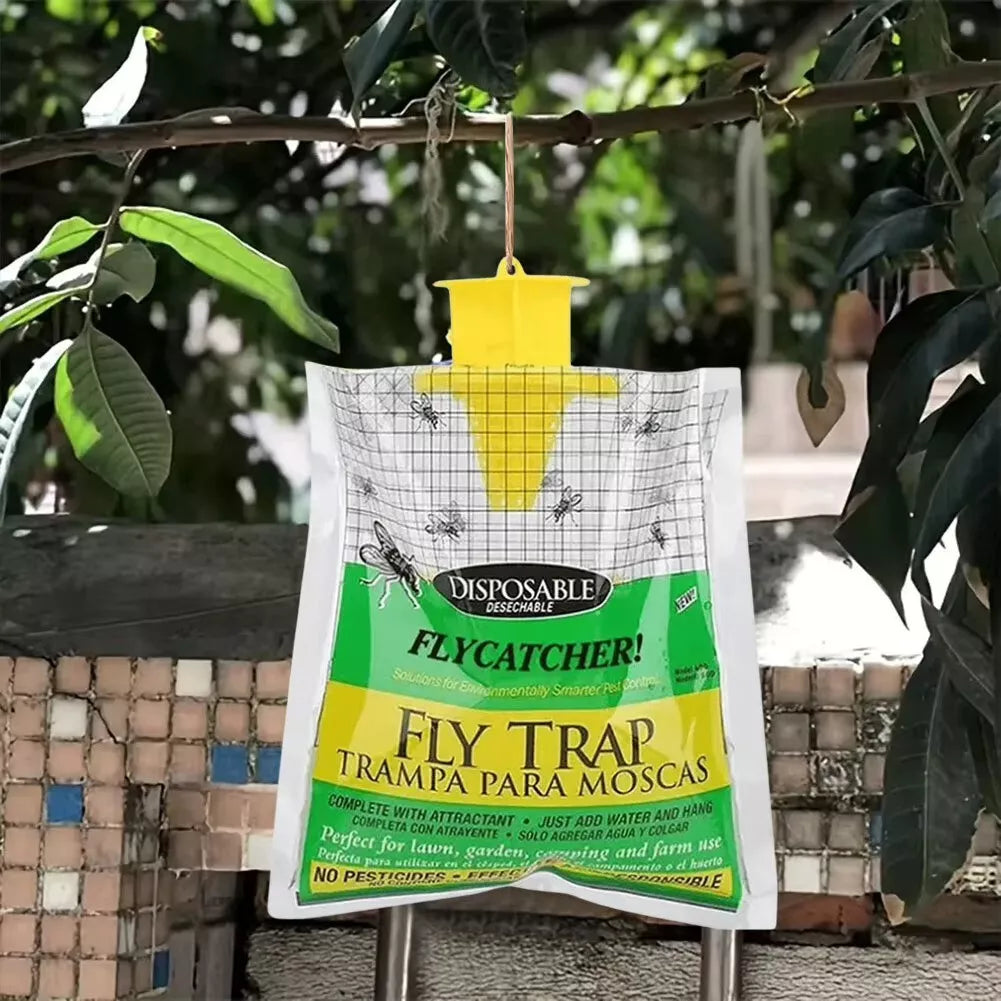 Fly trap hanging from a branch with greenery in the background