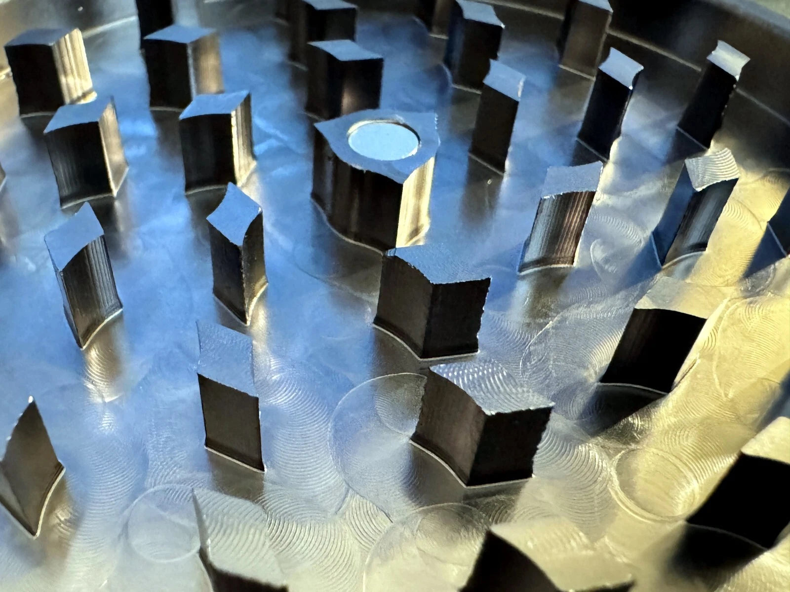 Close-up of CNC machined sharp aluminum grinding teeth.