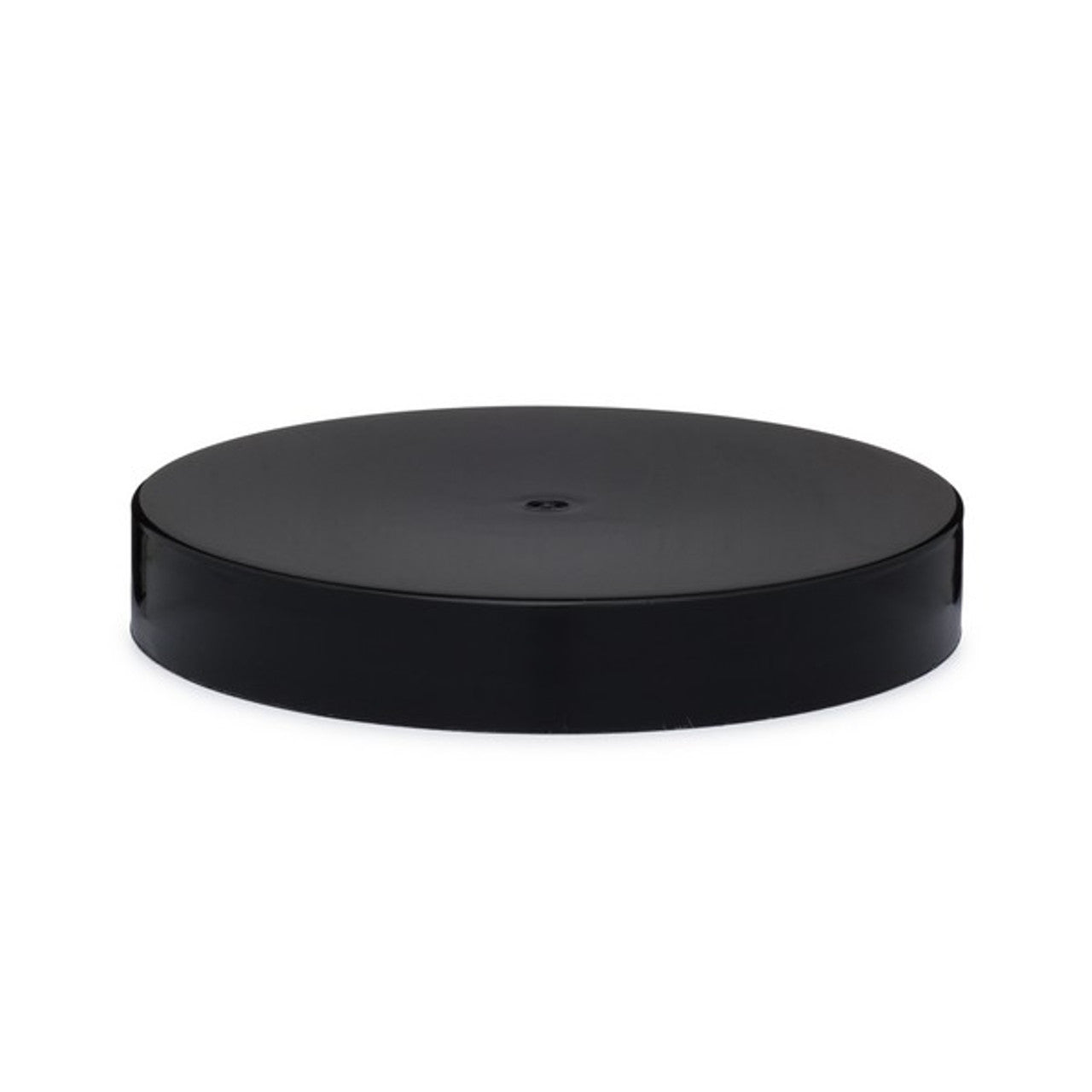 Black plastic jar lid on a white background