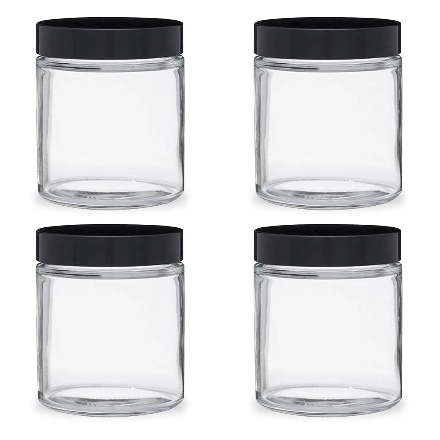 Four clear glass jars with black lids on a white background