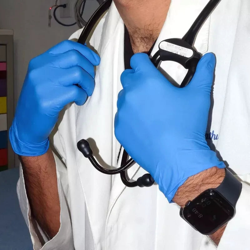 Person wearing blue nitrile exam gloves holding a stethoscope, with a focus on medical equipment.