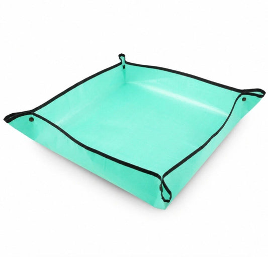 Turquoise plant repotting mat with black trim on a white background