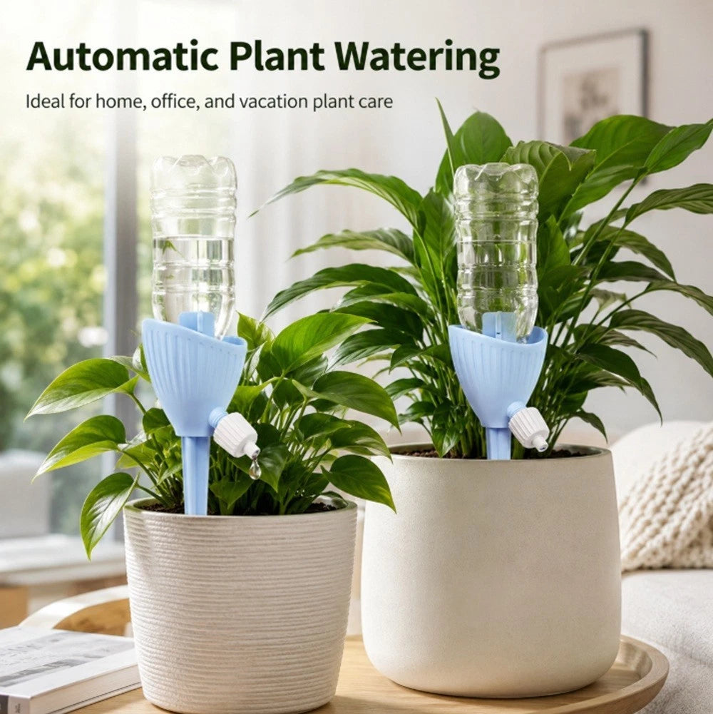 Two potted houseplants on a wooden tray in a bright indoor setting, each with a light blue automatic plant watering device holding a clear plastic water bottle. Text at the top reads 'Automatic Plant Watering' and 'Ideal for home, office, and vacation plant care.