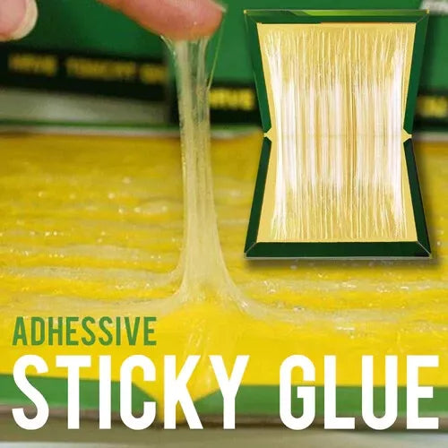 Sticky glue on mouse trap being pulled up with finger to show strength of adhesive glue