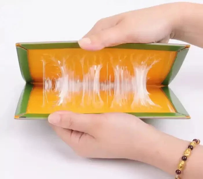 hands pulling open sticky glue mouse trap