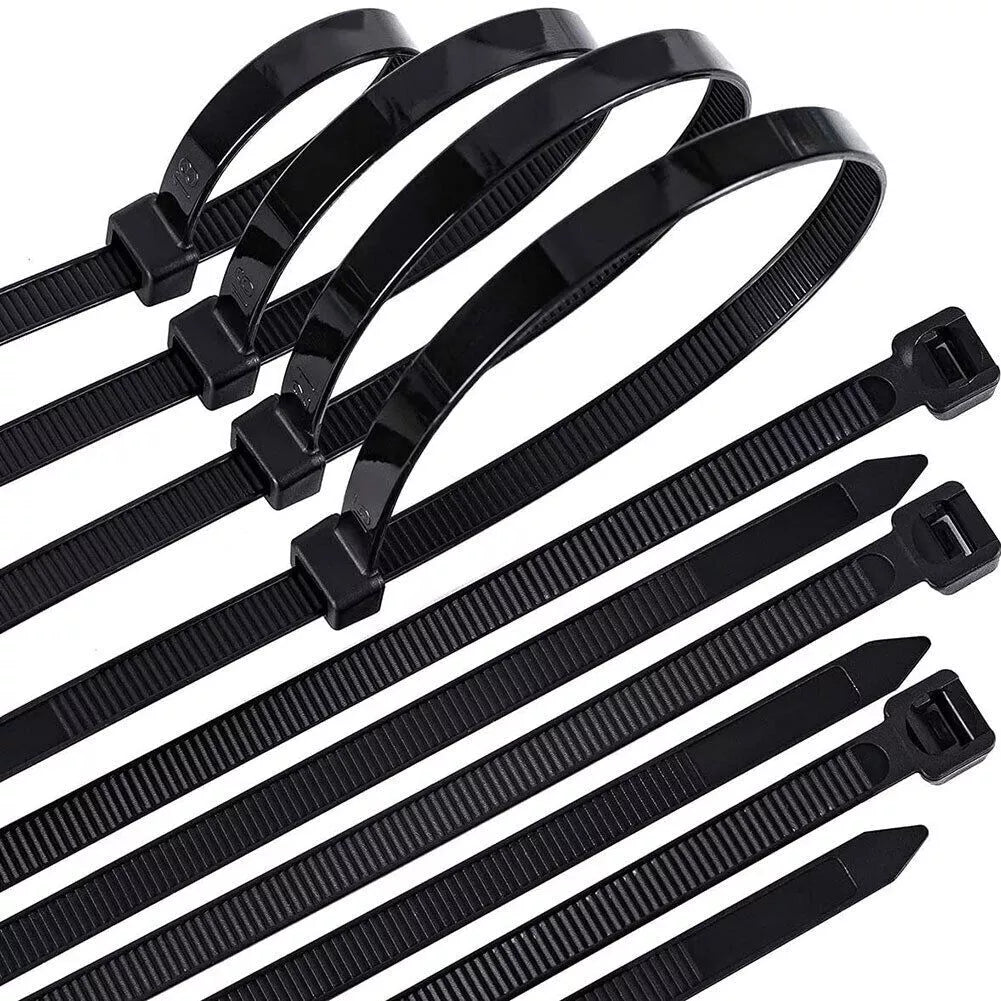 Black cable ties arranged on a white background