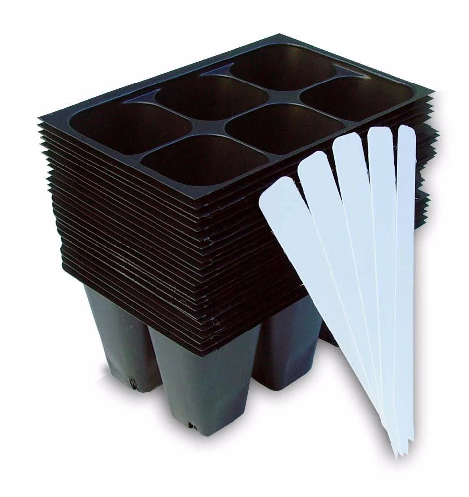 Stack of black plastic seed propagation trays with white labels on a white background
