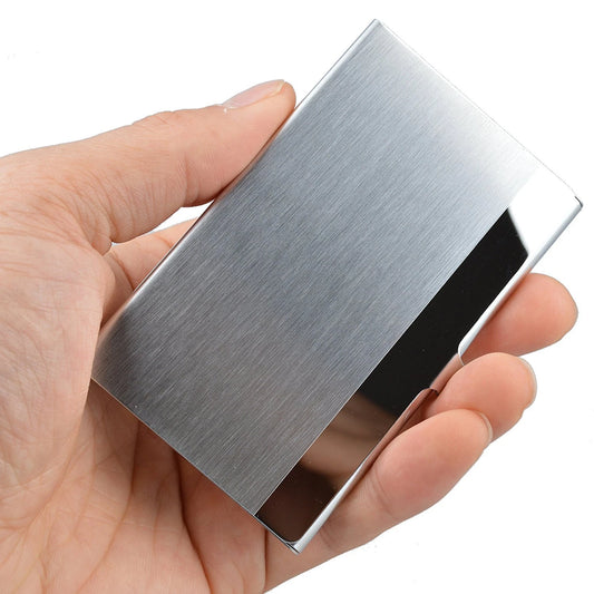 Hand holding a metallic silver stainless steel business card holder against a white background