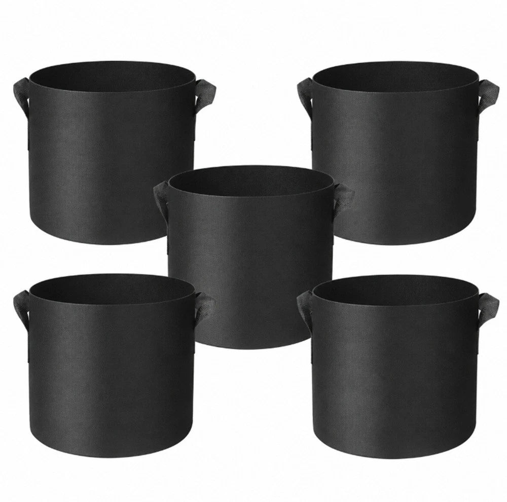 Five matte black fabric plant grow bags with side handles, arranged on a plain white background.