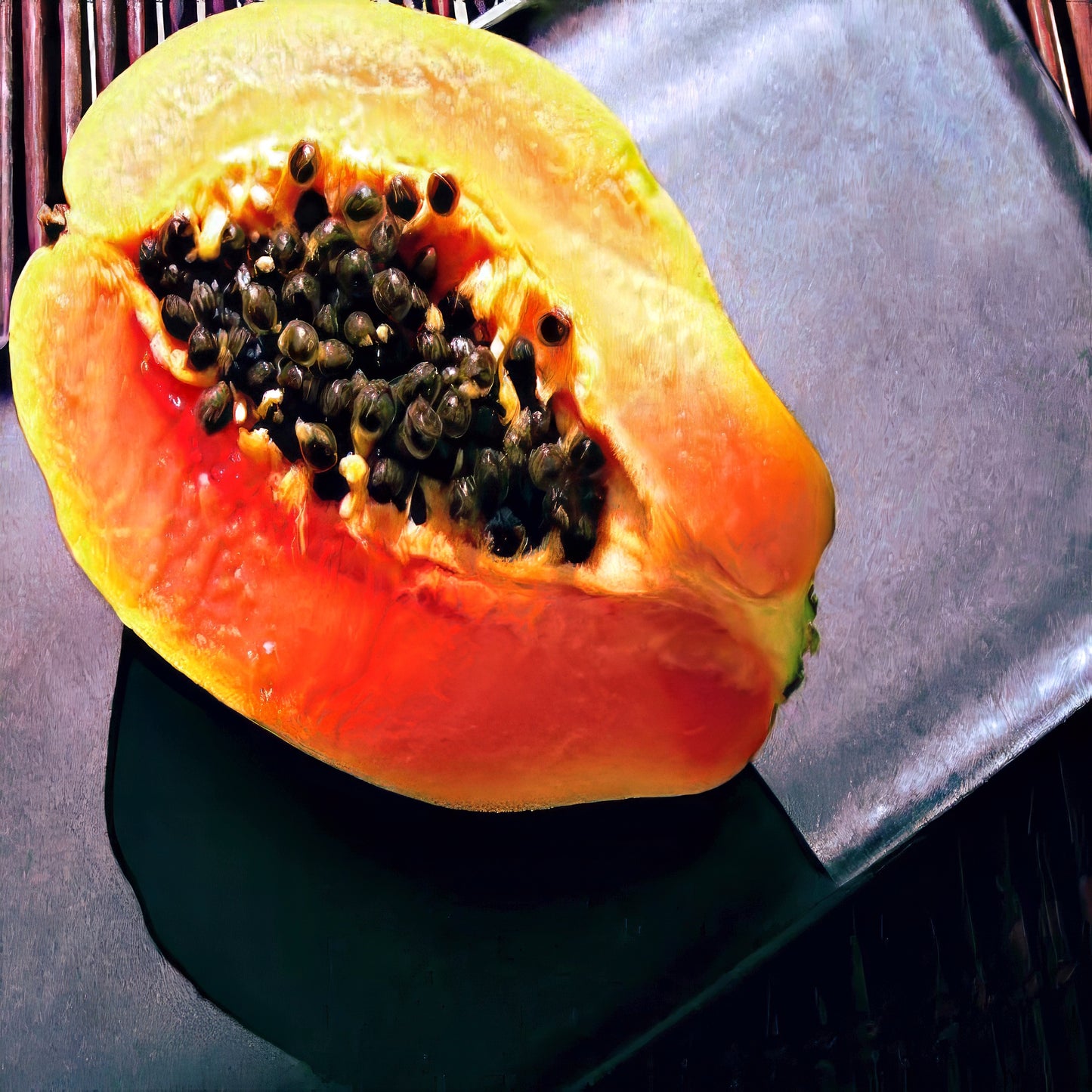 Halved Dwarf Hawaiian Solo Sunrise papaya on a dark surface