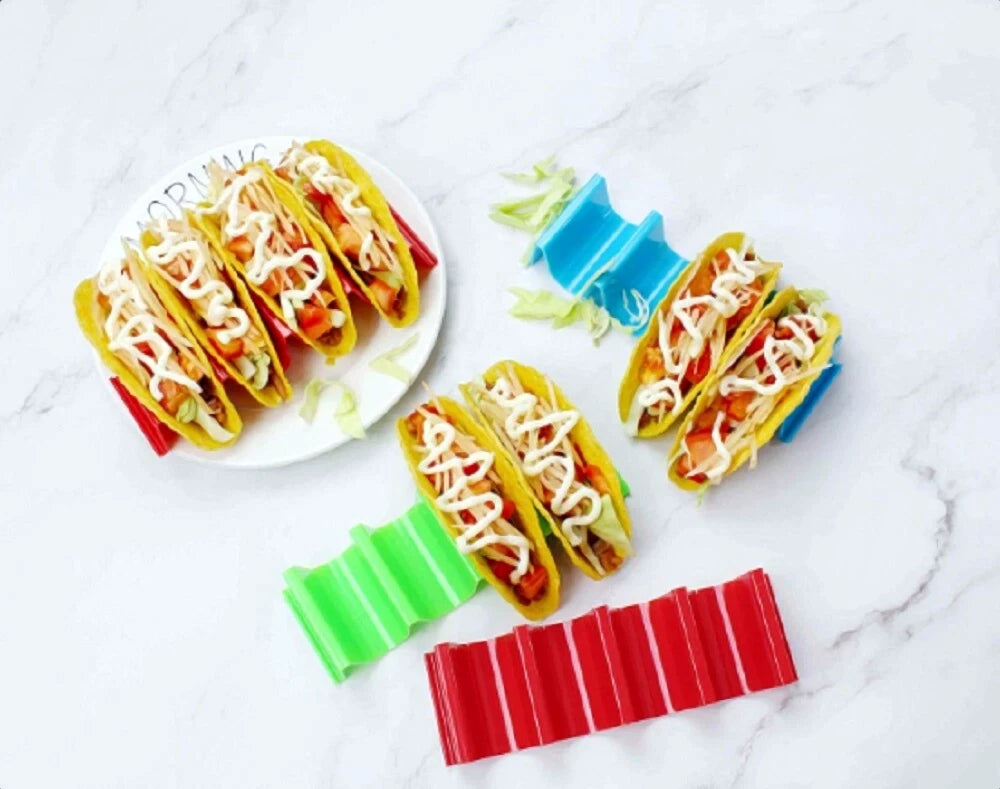 Colorful taco shell holders on a marble surface with a plate of tacos.