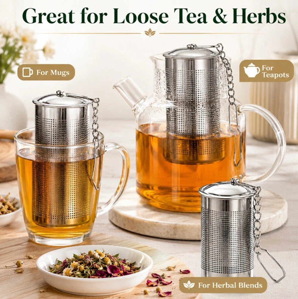 Tea infusers with tea and herbs on a wooden surface