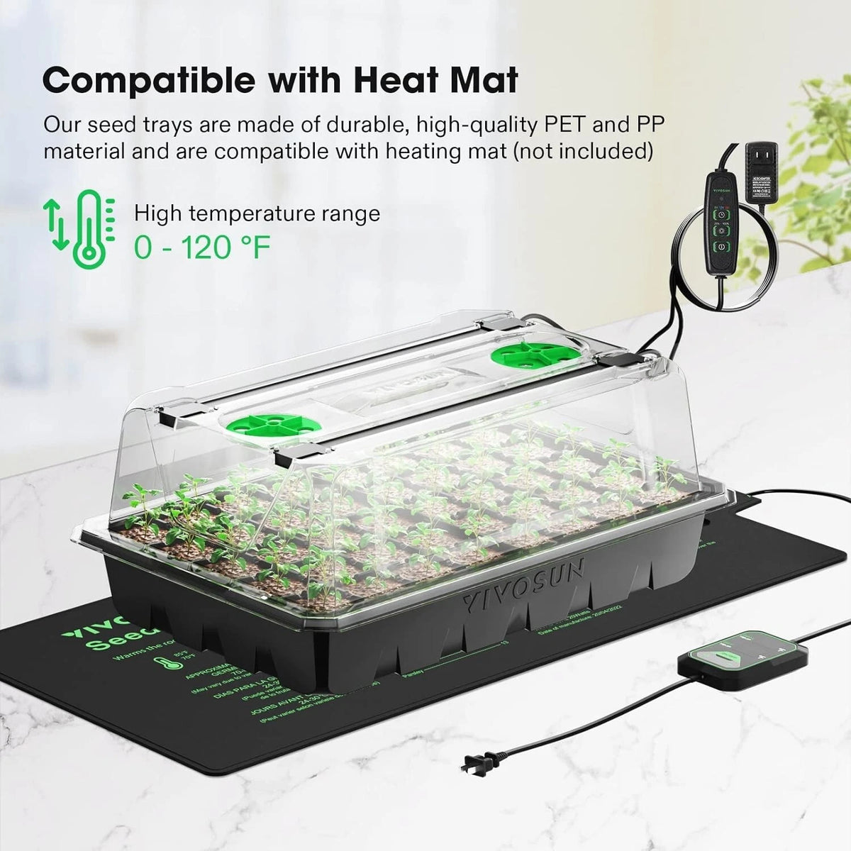 Seedling tray in humidity dome with heating mat and power supply on a light background