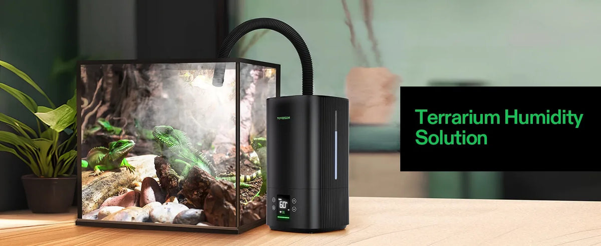 A black terrarium with VIVOSUN Intelligent Wi-Fi Humidifier device shown next to a glass terrarium with a frog and moss, on a wooden table with a green plant in the background. A text overlay on the right reads 'Terrarium Humidity Solution'.