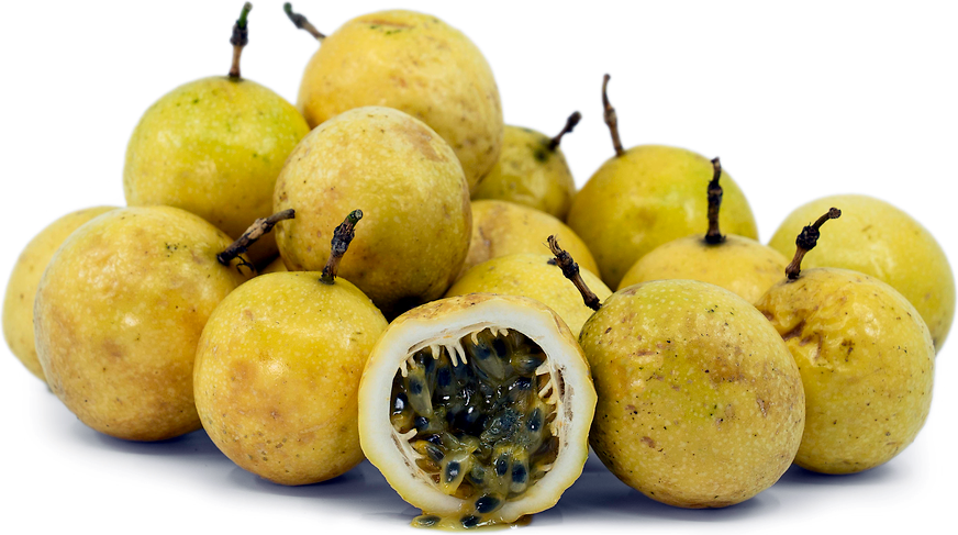 Yellow passion fruits with one cut open to reveal seeds on a white background. (Passiflora edulis f. flavicarpa)